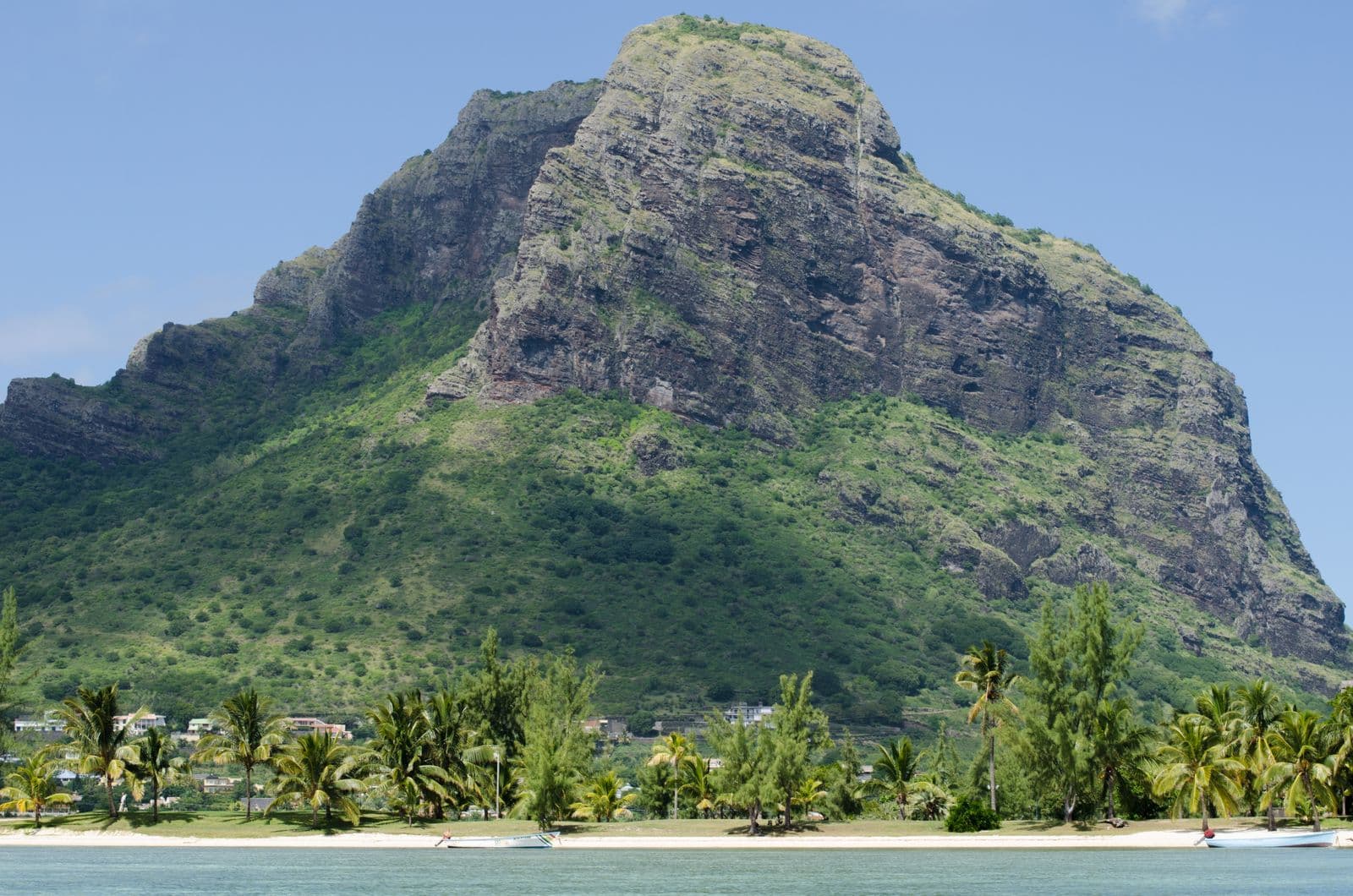 The flat turquoise lagoon and palm-lined shore at Le Morne